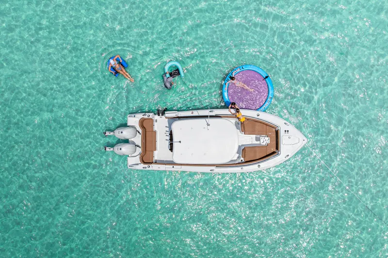  Yacht Photos Pics Aerial view of 2026 Sea Hunt Ultra 265 SE boat on clear turquoise water.