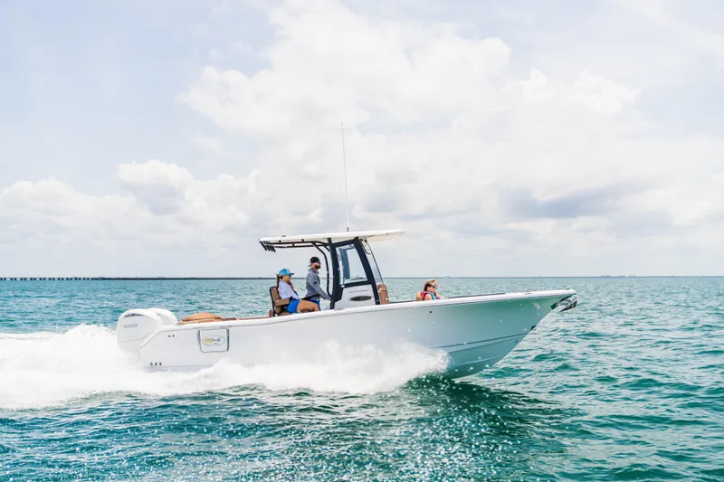  Yacht Photos Pics 2026 Sea Hunt Ultra 265 SE cruising on open water under a clear sky.