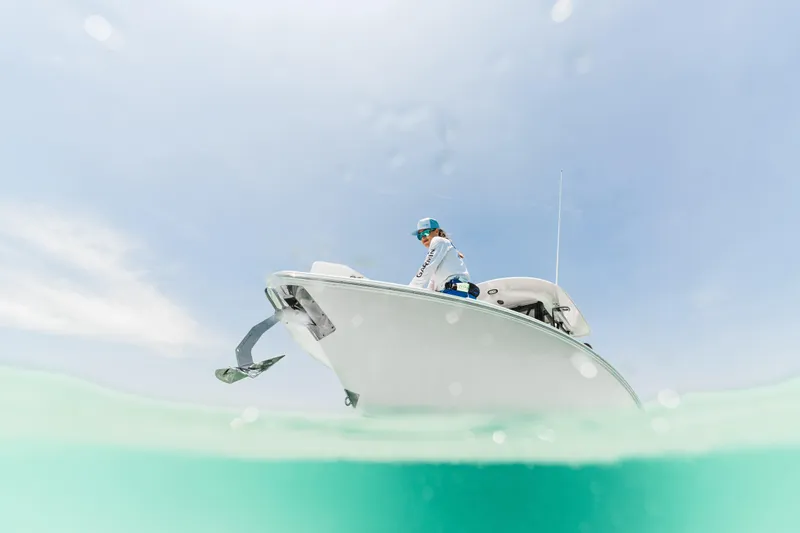  Yacht Photos Pics 2026 Sea Hunt Ultra 265 SE boat on clear water, person onboard, sunny day.