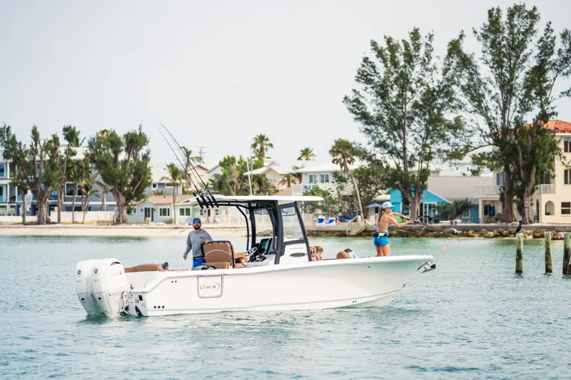 Yacht Photos Pics 2026 Sea Hunt Ultra 265 SE boat on water, people fishing, coastal background.