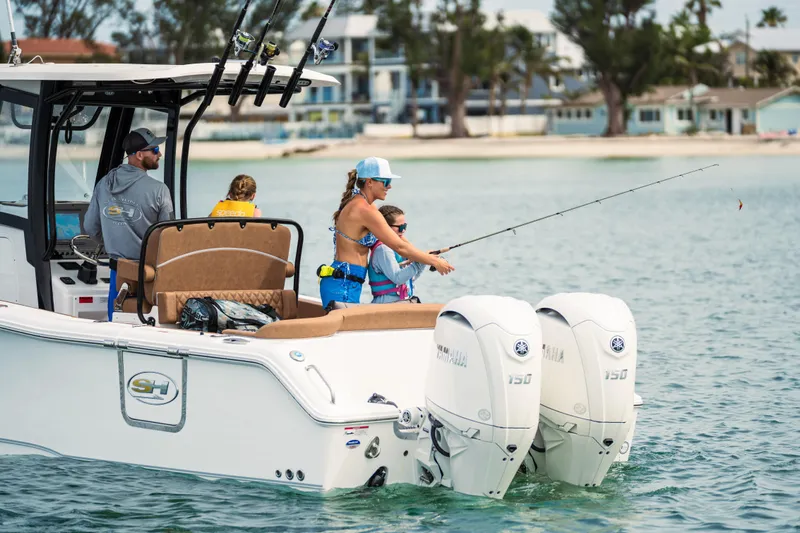  Yacht Photos Pics Family fishing on a 2026 Sea Hunt Ultra 265 SE boat in calm waters.