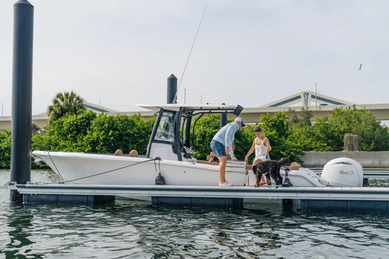  Yacht Photos Pics 2026 Sea Hunt Ultra 265 SE boat docked with people and a dog onboard.