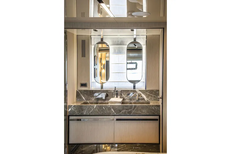  Yacht Photos Pics Luxurious bathroom interior of 2026 Cranchi Sessantasette 67 Fly yacht, featuring elegant marble finishes.