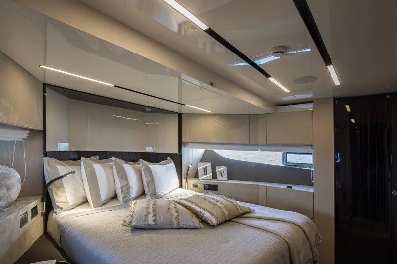  Yacht Photos Pics Luxurious bedroom interior of 2026 Cranchi Sessantasette 67 Fly yacht, featuring elegant design and modern lighting.