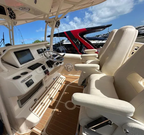  Yacht Photos Pics 2018 Grady-White Canyon 336 boat interior with helm, steering wheel, and comfortable seating.