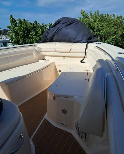  Yacht Photos Pics 2018 Grady-White Canyon 336 boat interior with seating and covered equipment.