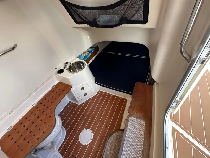  Yacht Photos Pics 2018 Grady-White Canyon 336 cabin interior with wood flooring and compact amenities.