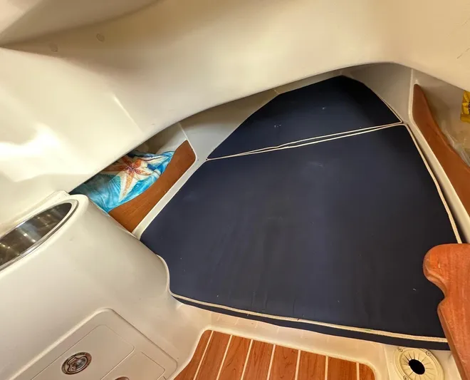  Yacht Photos Pics 2018 Grady-White Canyon 336 cabin interior with blue cushions and wood flooring.