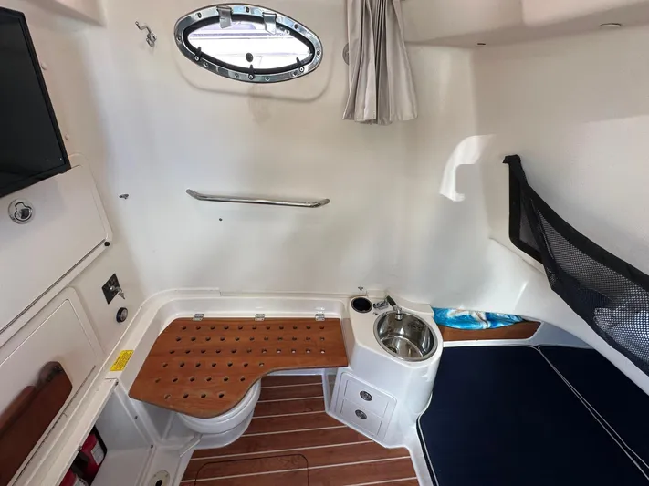  Yacht Photos Pics Interior of 2018 Grady-White Canyon 336 boat, featuring seating, sink, and porthole window.