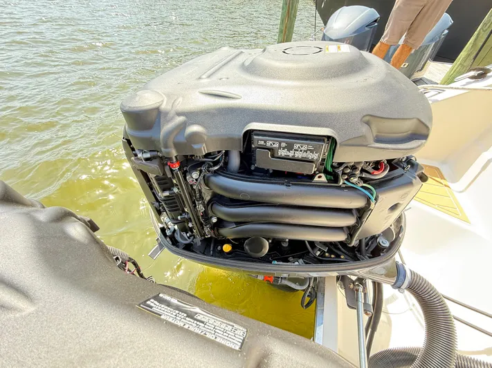 My Ginny Yacht Photos Pics 2014 Pursuit ST 310 Sport outboard engine, open cover, docked by water.