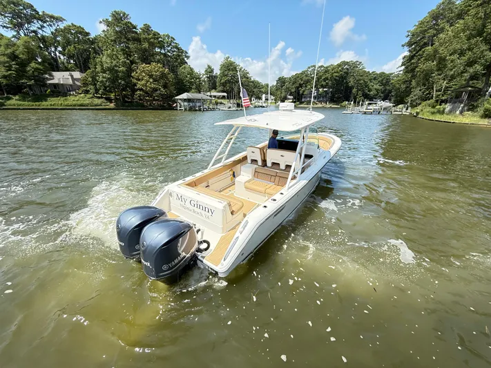 My Ginny Yacht Photos Pics 2014 Pursuit ST 310 Sport boat cruising on a scenic waterway.