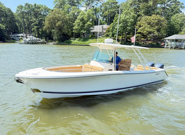 My Ginny Yacht Photos Pics 2014 Pursuit ST 310 Sport boat cruising on a scenic river.