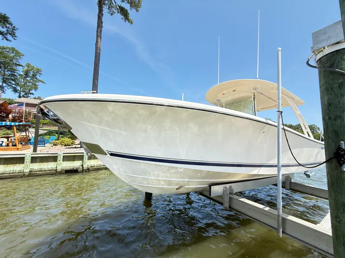 My Ginny Yacht Photos Pics 2014 Pursuit ST 310 Sport boat docked on a sunny day.