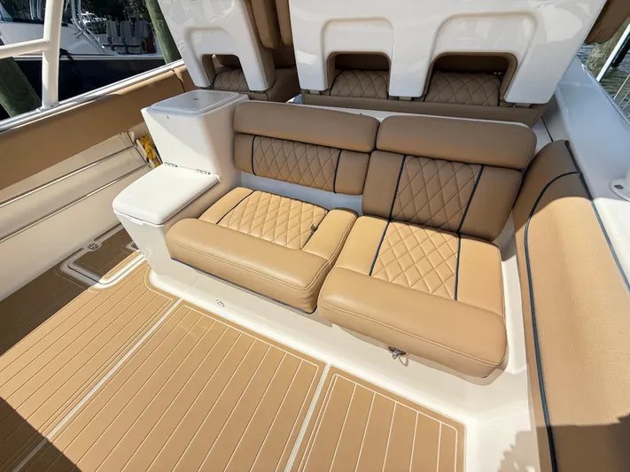 My Ginny Yacht Photos Pics Luxurious seating on 2014 Pursuit ST 310 Sport boat with tan upholstery and diamond stitching.