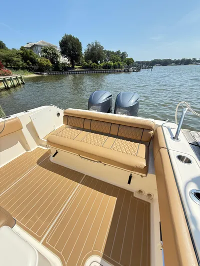 My Ginny Yacht Photos Pics 2014 Pursuit ST 310 Sport boat with tan seating and dual engines on a sunny day.
