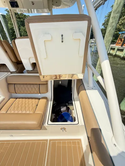 My Ginny Yacht Photos Pics 2014 Pursuit ST 310 Sport boat interior with storage compartment open.