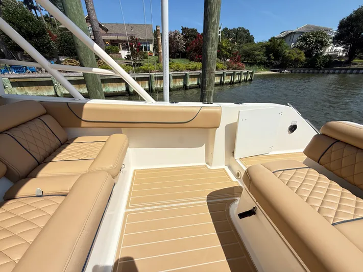 My Ginny Yacht Photos Pics 2014 Pursuit ST 310 Sport boat interior with tan leather seating and waterfront view.