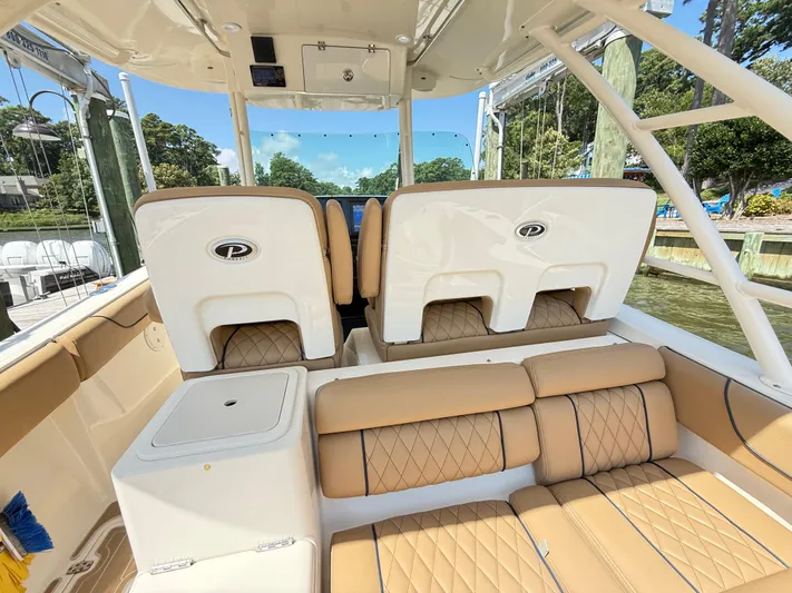 My Ginny Yacht Photos Pics 2014 Pursuit ST 310 Sport boat interior with tan seating and sleek design.