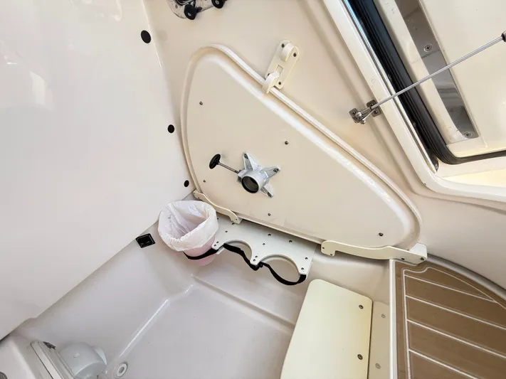 My Ginny Yacht Photos Pics 2014 Pursuit ST 310 Sport interior cabin with storage and seating area.