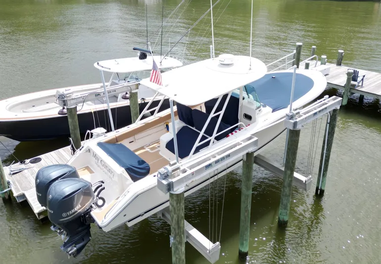 My Ginny Yacht Photos Pics 2014 Pursuit ST 310 Sport boat docked with dual Yamaha engines, covered seating, and American flag.