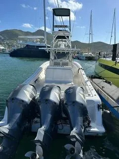  Yacht Photos Pics 2017 Invincible 39 Open Fisherman boat with triple outboard engines docked at marina.