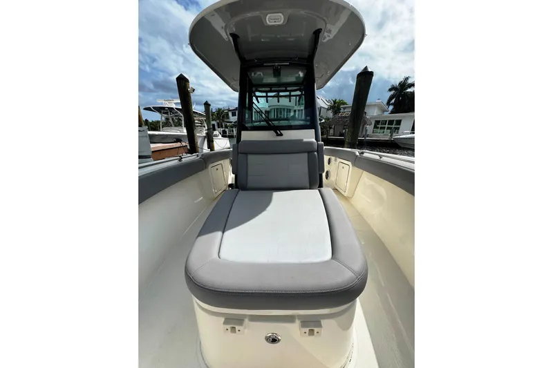  Yacht Photos Pics 2024 Boston Whaler 280 Outrage boat interior with cushioned seating and sleek design.