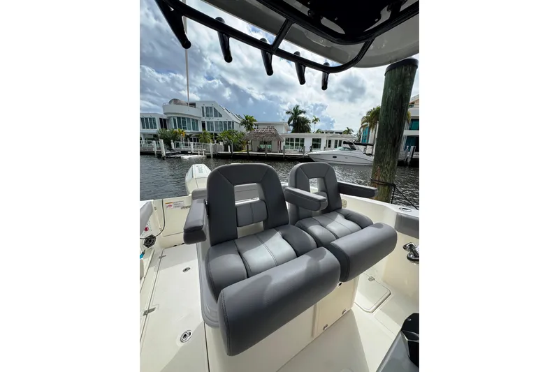  Yacht Photos Pics 2024 Boston Whaler 280 Outrage boat interior with luxurious seating and waterfront view.
