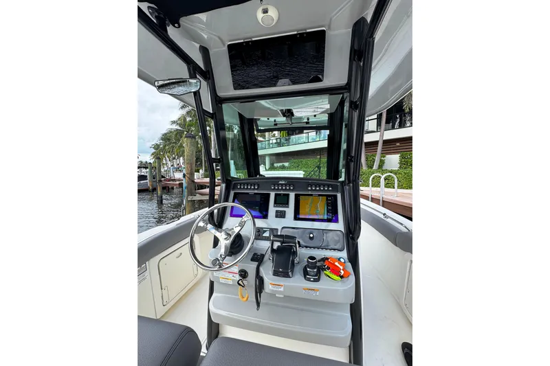  Yacht Photos Pics 2024 Boston Whaler 280 Outrage helm with advanced navigation systems and sleek design.