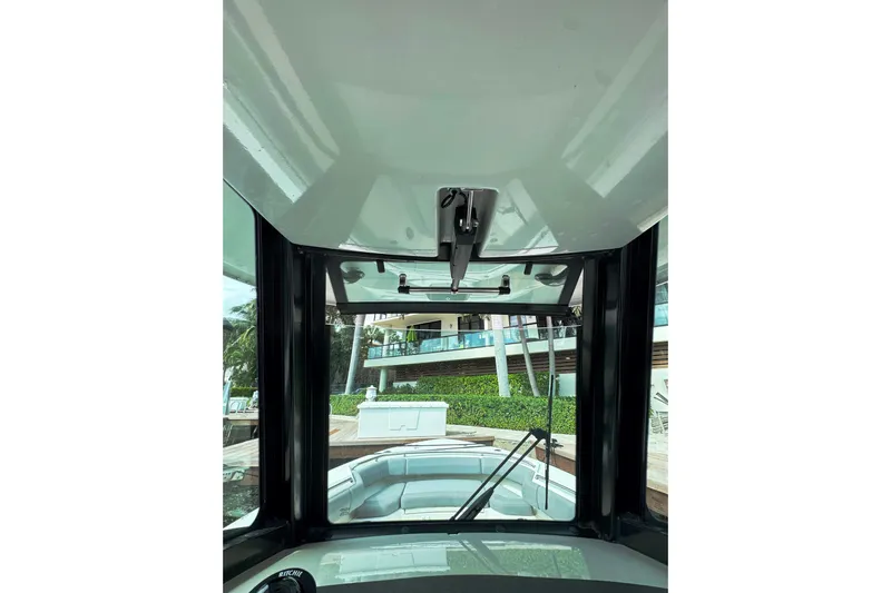  Yacht Photos Pics 2024 Boston Whaler 280 Outrage boat interior view with windshield and console.