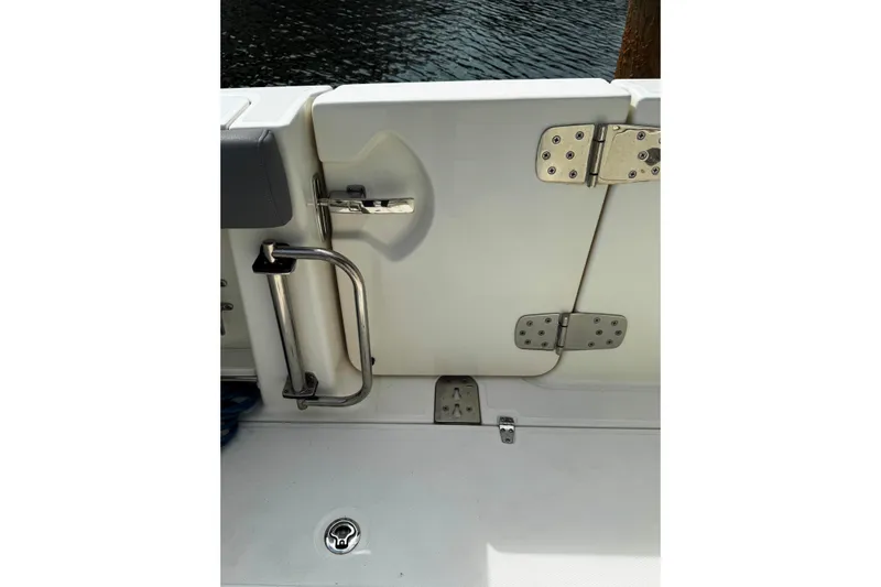  Yacht Photos Pics 2024 Boston Whaler 280 Outrage boat door with stainless steel hardware and water view.