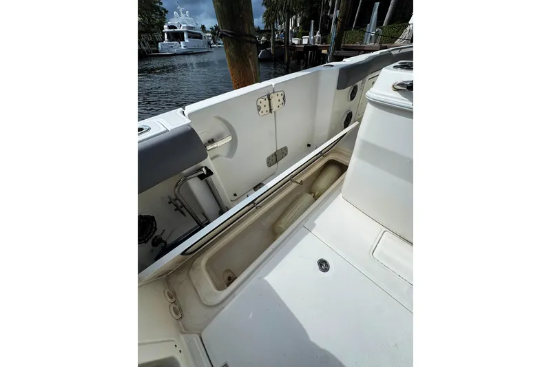  Yacht Photos Pics 2024 Boston Whaler 280 Outrage boat interior with open storage compartment.