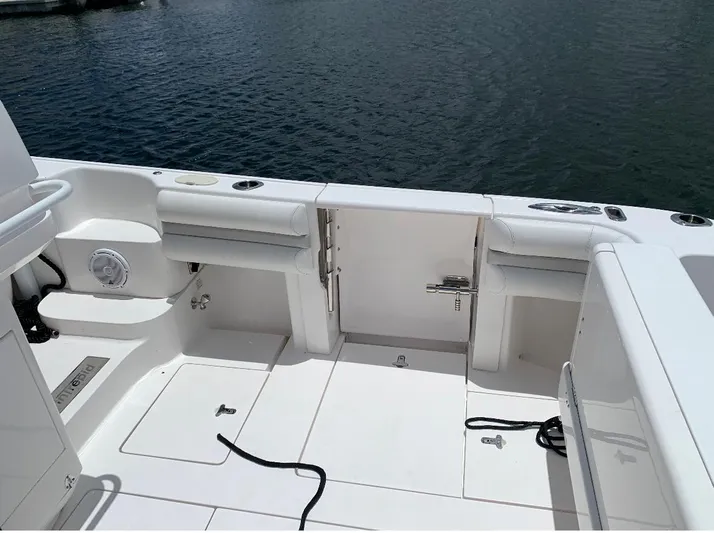  Yacht Photos Pics 2015 Intrepid 375 Walkaround boat deck with seating and storage compartments.