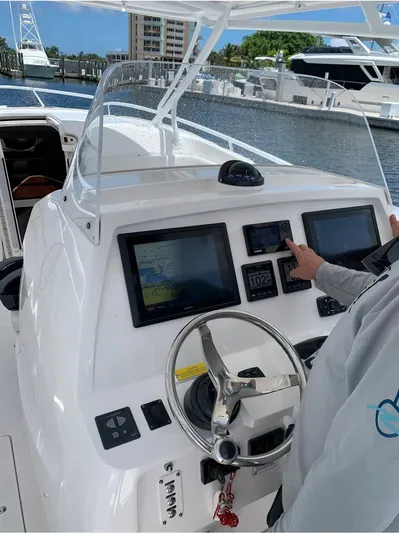  Yacht Photos Pics 2015 Intrepid 375 Walkaround boat dashboard with navigation screens and steering wheel.