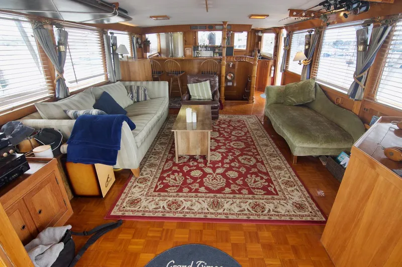 Grand Times Yacht Photos Pics Spacious 1969 Grand Banks Classic yacht interior with elegant furnishings and decorative rug.