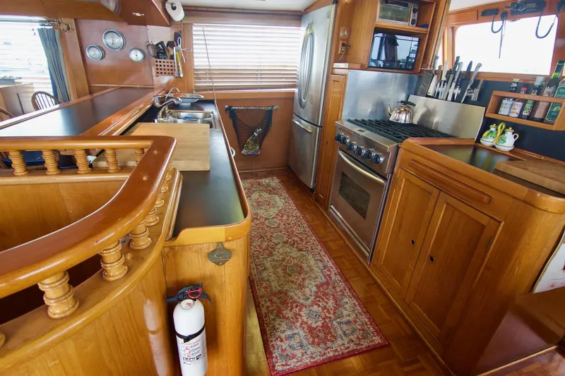 Grand Times Yacht Photos Pics Vintage 1969 Grand Banks Classic yacht kitchen with wooden cabinetry and modern appliances.