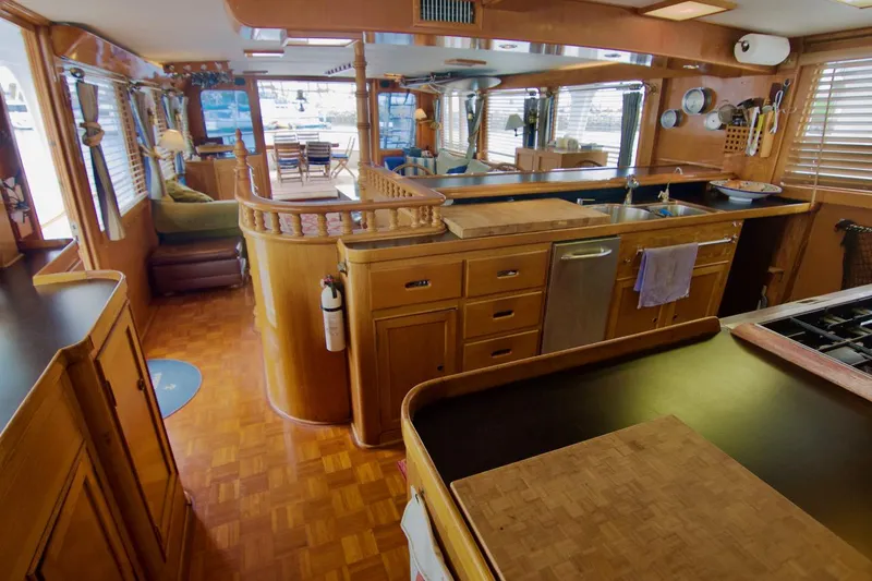 Grand Times Yacht Photos Pics Interior of a 1969 Grand Banks Classic yacht with wooden cabinetry and modern kitchen amenities.