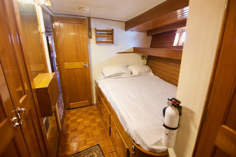 Grand Times Yacht Photos Pics Cozy cabin interior of 1969 Grand Banks Classic boat with wooden furnishings and bed.