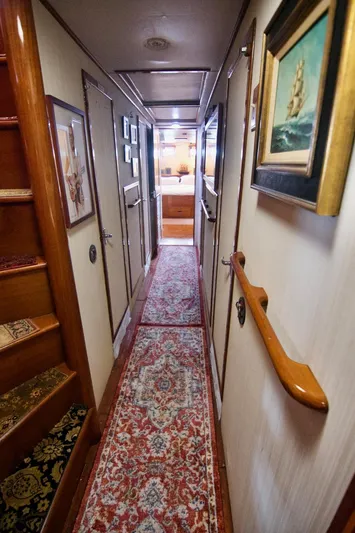 Grand Times Yacht Photos Pics Narrow hallway inside a 1969 Grand Banks Classic yacht, featuring wooden accents and nautical decor.