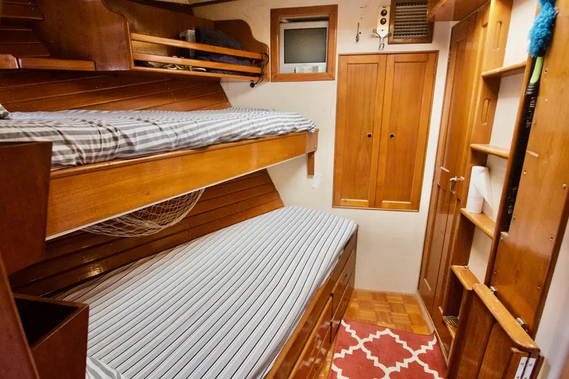 Grand Times Yacht Photos Pics Cozy 1969 Grand Banks Classic cabin with wooden bunk beds and nautical decor.