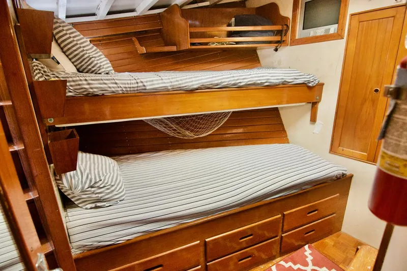 Grand Times Yacht Photos Pics 1969 Grand Banks Classic cabin with wooden bunk beds and striped bedding.