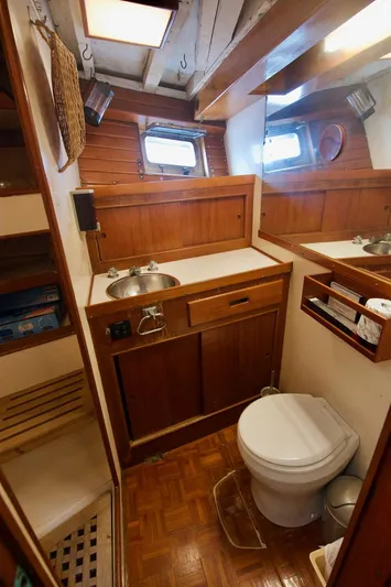 Grand Times Yacht Photos Pics 1969 Grand Banks Classic yacht bathroom with wooden cabinetry and nautical decor.