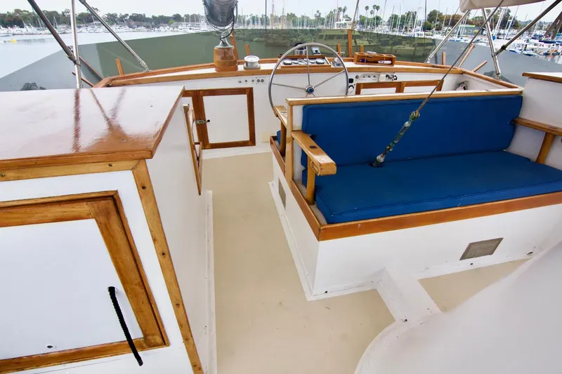 Grand Times Yacht Photos Pics 1969 Grand Banks Classic boat interior with wooden trim and blue seating.