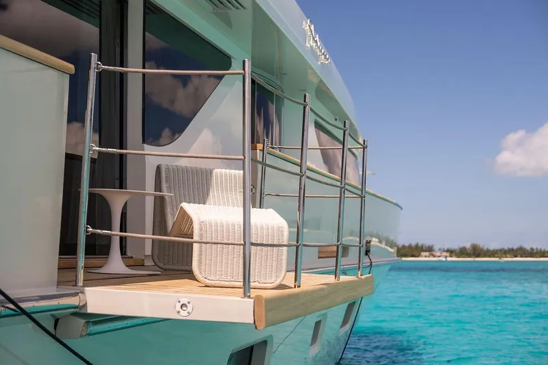 Halcyon Yacht Photos Pics Sanlorenzo SD112 yacht deck with chair, 2018 model, on clear blue water.