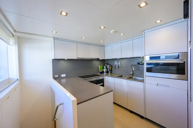 Halcyon Yacht Photos Pics Modern kitchen interior on 2018 Sanlorenzo SD112 yacht, featuring sleek cabinetry and stainless steel appliances.