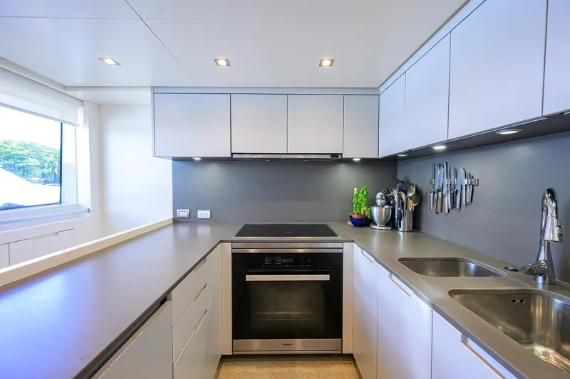 Halcyon Yacht Photos Pics Modern kitchen interior on 2018 Sanlorenzo SD112 yacht, featuring sleek cabinetry and stainless steel appliances.