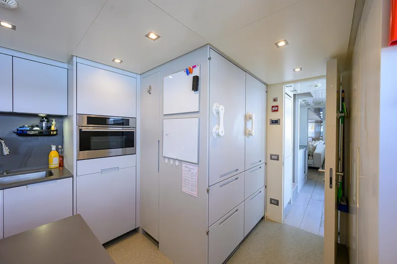 Halcyon Yacht Photos Pics Modern kitchen interior on 2018 Sanlorenzo SD112 yacht, featuring sleek cabinetry and built-in appliances.