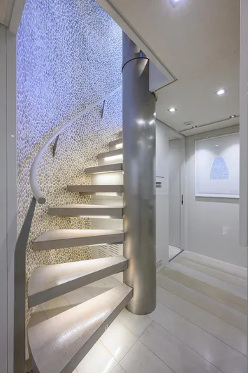 Halcyon Yacht Photos Pics Modern spiral staircase on 2018 Sanlorenzo SD112 yacht, featuring elegant lighting and sleek design.
