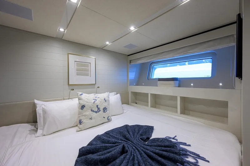 Halcyon Yacht Photos Pics Luxurious bedroom interior of 2018 Sanlorenzo SD112 yacht with modern decor and large window.