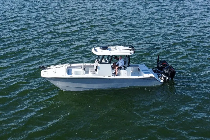  Yacht Photos Pics 2024 Freeman 28 boat on open water, featuring dual engines and sleek design.