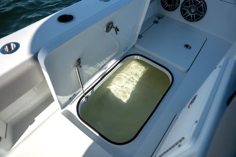  Yacht Photos Pics 2024 Freeman 28 boat interior with open storage compartment and speakers.